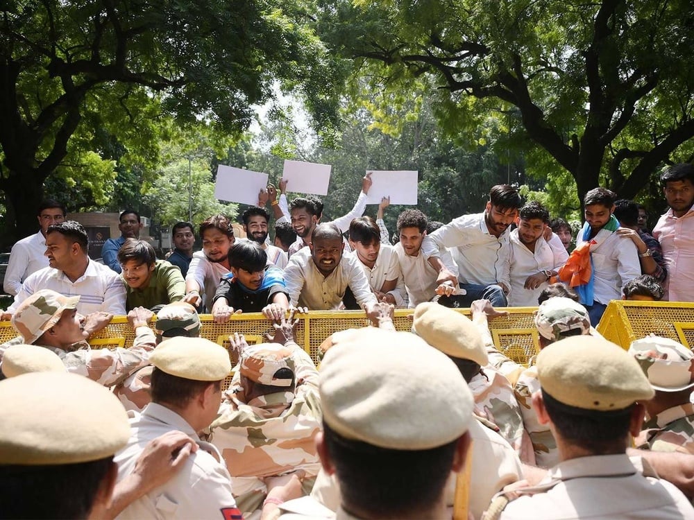 Police detain ~1,000 and file three FIRs as opposition protests demand CEC Gyanesh Kumar's resignation over SIR electoral-roll revisions; journalists allege police sexual harassment