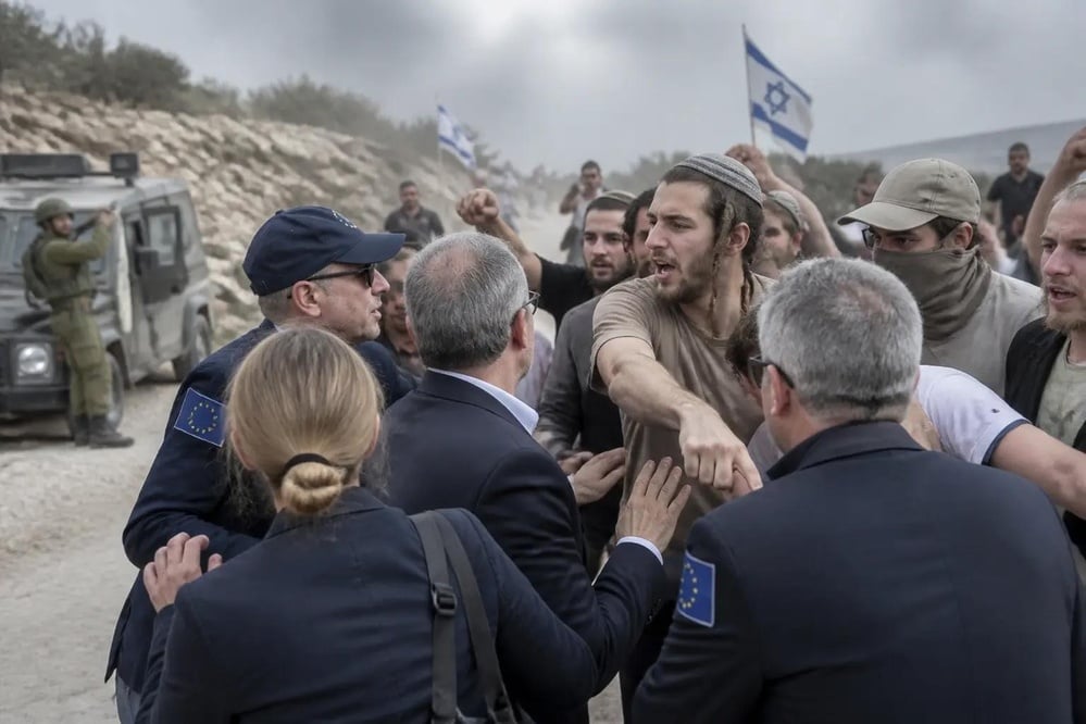 Masked Israeli settlers attacked a convoy of European diplomats and beat a French mayor in Taybeh, West Bank, during the olive harvest, drawing global condemnations