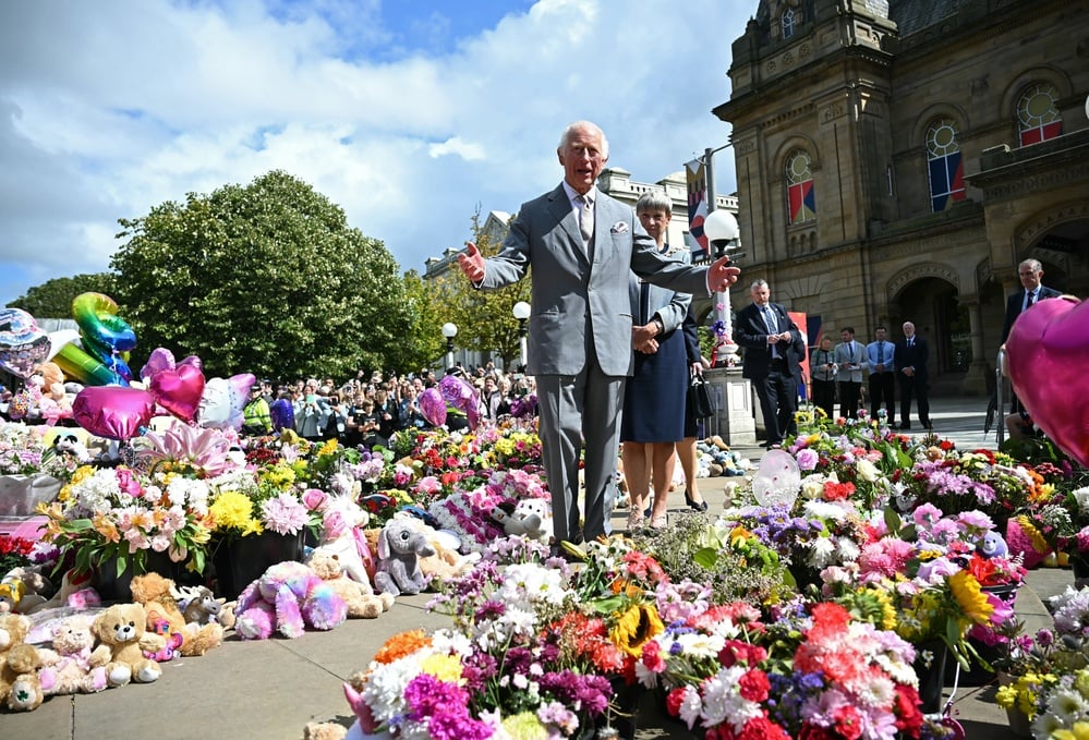 King Charles' visit highlights communal mourning and calls for healing.