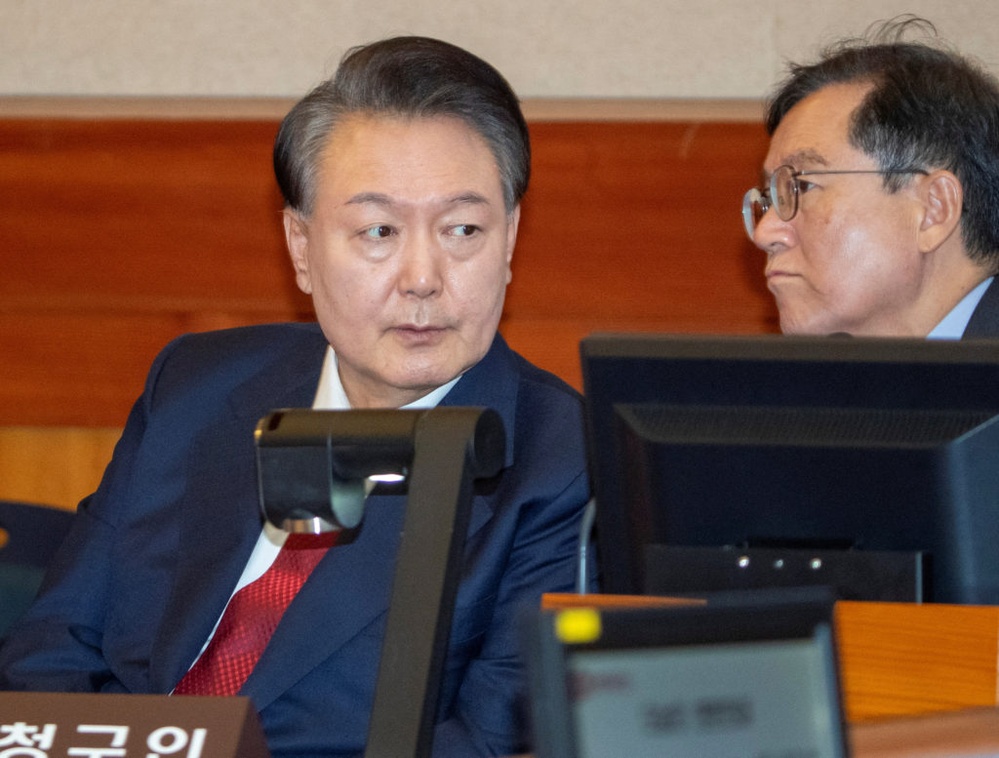 Impeached South Korean president appears in 2 different courts while defending his martial law decree