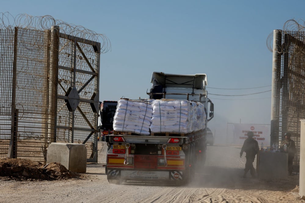 Humanitarian aid delivery to Gaza halted amid security fears.