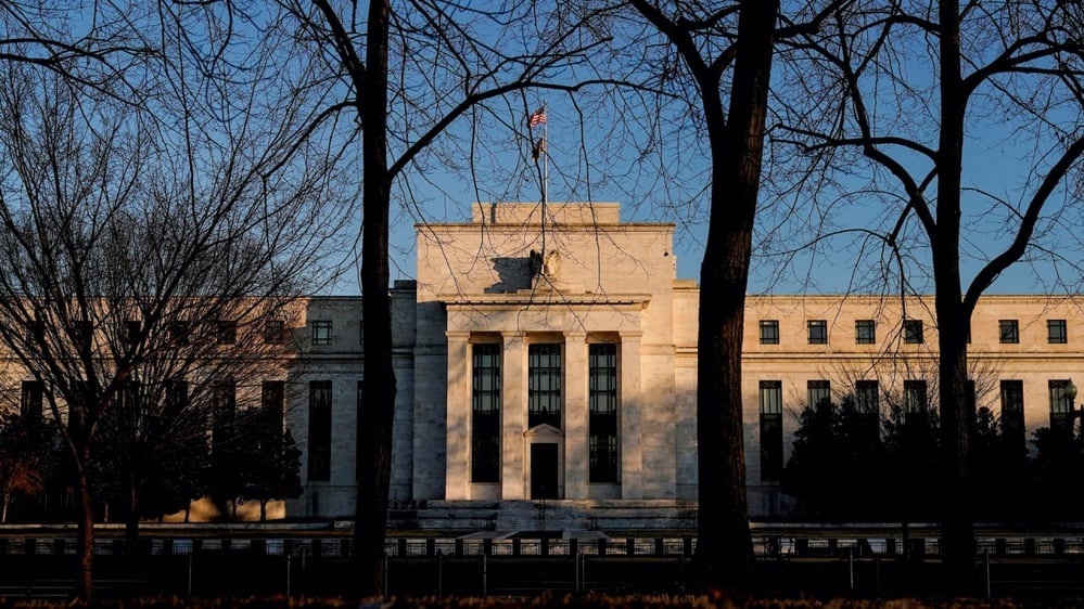 Federal Reserve holds interest rates steady, forecasts slow growth