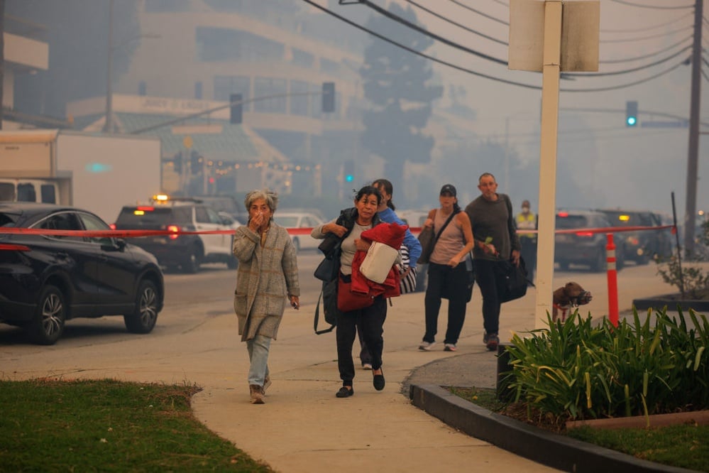 Palisades Fire prompts massive LA evacuations amid severe weather conditions.